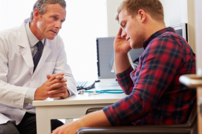 Frustrated worker in doctor's office, dealing with a workplace injury and medical treatment challenges