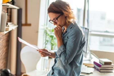 Frustrated worker reviewing financial documents related to workers' compensation claims